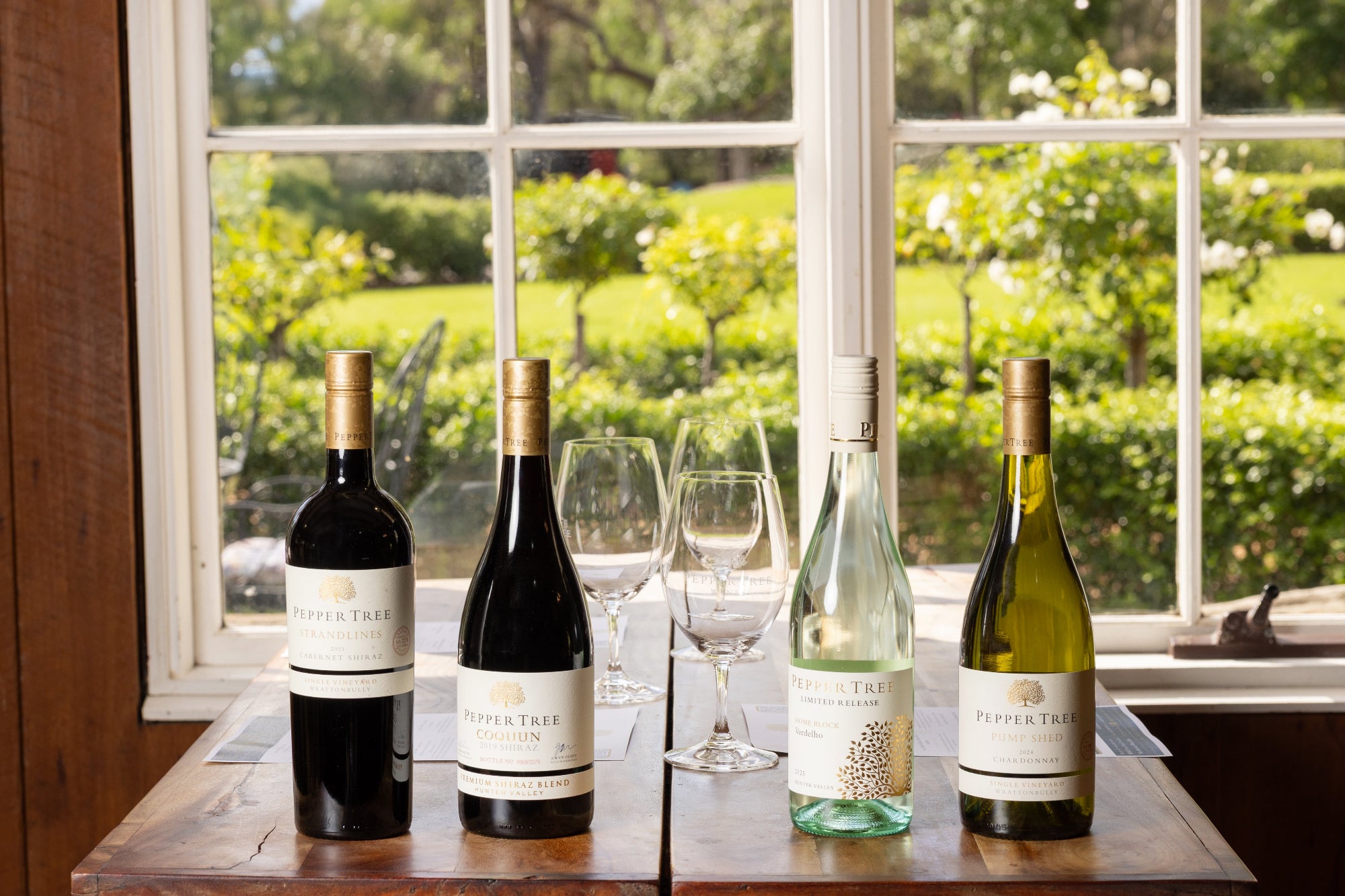 Wines and glasses on the table at a Pepper Tree Wine tasting